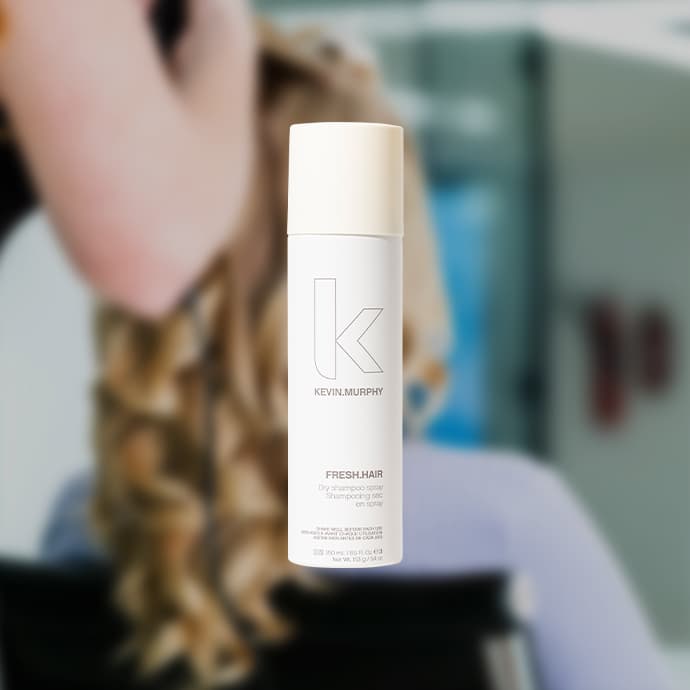 Person with curled blonde hair and white hair product - overlay